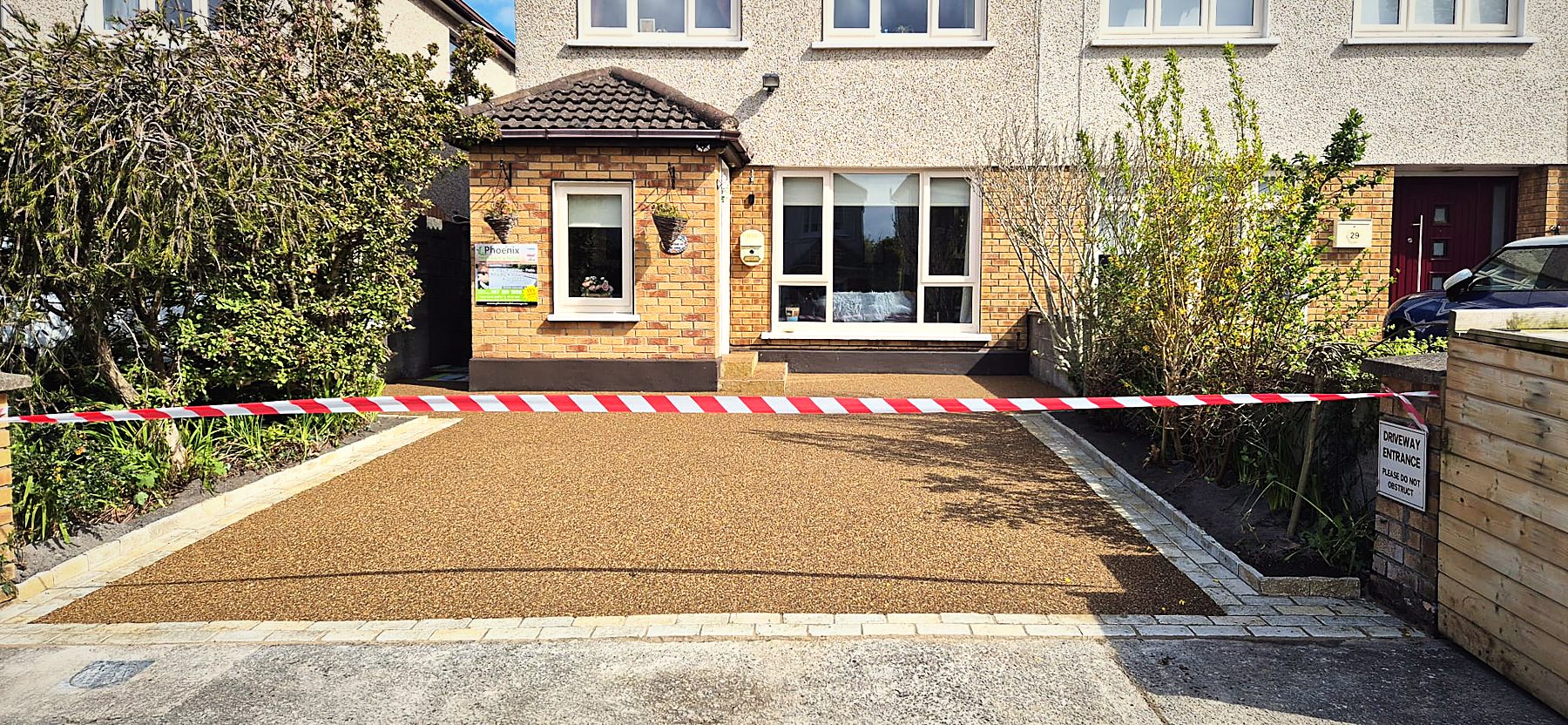 Resin-bound driveway with silver granite trim at a semi-detached house