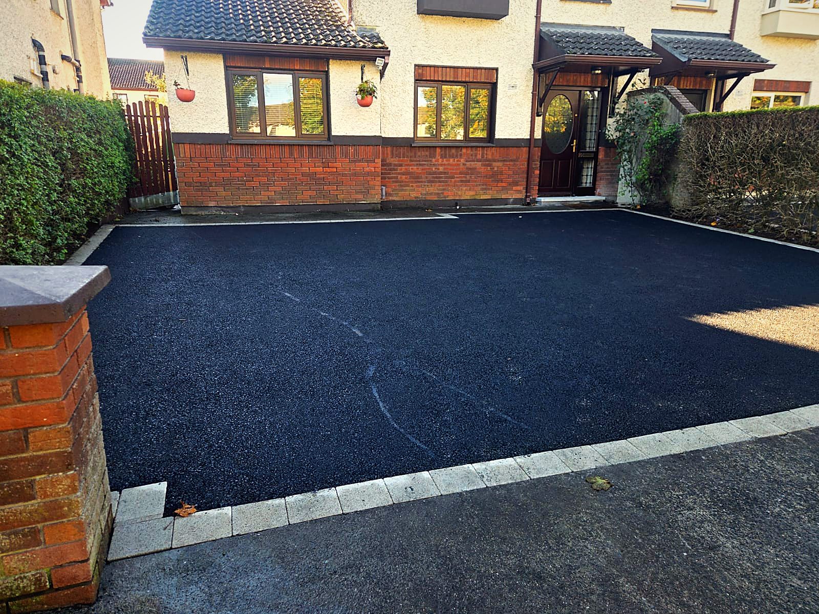 New black tarmac driveway with light granite border